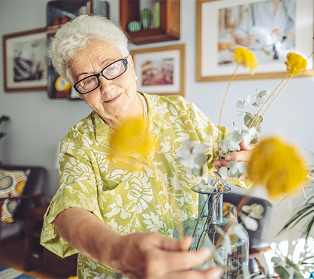 woman with valvular heart disease looking at her flowers