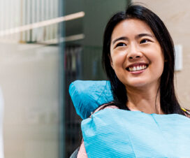 woman smiling at dentist in dentist chair