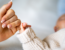 Parent holding baby's hand.