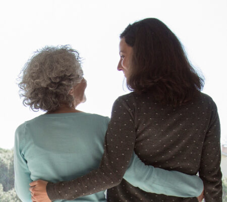 dementia caregiver embracing loved one with dementia
